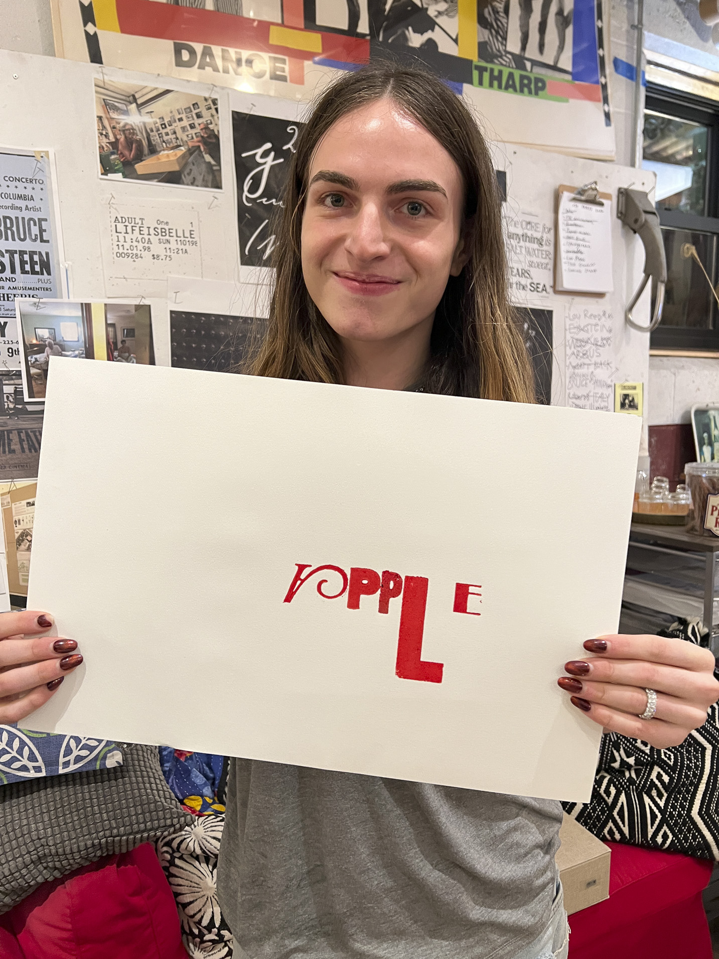 Tisch student holding a print made with hand-set type